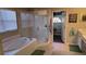 Bathroom boasts a large soaking tub, a separate shower, and an updated vanity at 8999 Founders Cir, Palmetto, FL 34221