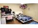 Bedroom with a full-size bed, desk, and plush toys at 8999 Founders Cir, Palmetto, FL 34221