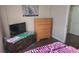 Bedroom with a dresser, TV, and dark wood floor at 8999 Founders Cir, Palmetto, FL 34221