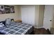 Bedroom with a bed, large closet, and dark wood floor at 8999 Founders Cir, Palmetto, FL 34221