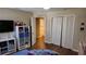 Spacious bedroom with wood floors, large closet, and bathroom access at 8999 Founders Cir, Palmetto, FL 34221