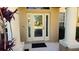 Light beige front door with glass panels and arched transom at 8999 Founders Cir, Palmetto, FL 34221