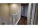 Upstairs hallway with hardwood floors and doors at 8999 Founders Cir, Palmetto, FL 34221