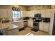 Well-equipped kitchen with ample cabinet space and stainless steel appliances at 8999 Founders Cir, Palmetto, FL 34221