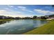 Peaceful lake view with lush landscaping and homes at 8999 Founders Cir, Palmetto, FL 34221