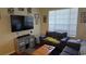 Cozy living room featuring comfortable seating and a large TV at 8999 Founders Cir, Palmetto, FL 34221