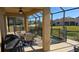 Screened-in pool area with patio furniture and lake view at 8999 Founders Cir, Palmetto, FL 34221