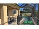 Relaxing screened-in pool and patio area with lake view at 8999 Founders Cir, Palmetto, FL 34221