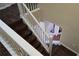 Elegant staircase with dark wood and white railing at 8999 Founders Cir, Palmetto, FL 34221