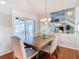 Dining room with wood table and view to enclosed patio at 9709 Fredericksburg Rd, Tampa, FL 33635