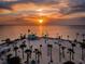 Aerial sunset view of beach with palm trees and gazebo at 1010 Bowsprit Ln # 0, Holiday, FL 34691