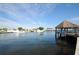 Scenic waterfront view with boats and a thatched gazebo at 1010 Bowsprit Ln # 0, Holiday, FL 34691