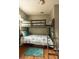 Cozy bunk bedroom featuring gray bunk bed with ladder and teal accents at 10405 N Woodmere Rd, Tampa, FL 33617