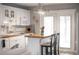 Bright kitchen with white cabinetry, a butcher block countertop, and stainless steel appliances at 10405 N Woodmere Rd, Tampa, FL 33617