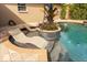 Close-up of the pool with built-in lounge chairs and custom tile work at 10405 N Woodmere Rd, Tampa, FL 33617