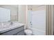 Bathroom with gray vanity, marble countertop, and tub/shower combo at 10588 Farm Hill Ave, Land O Lakes, FL 34638