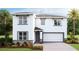 Two-story house with gray accents, stone detailing, and a two-car garage at 10588 Farm Hill Ave, Land O Lakes, FL 34638