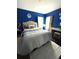 Bedroom with a full bed, blue walls, and window coverings at 1112 Lake Shore Ranch Dr, Seffner, FL 33584