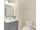 Simple bathroom with gray vanity, toilet, and mirror at 11120 Kempton Vista Dr, Riverview, FL 33579