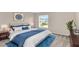 Bedroom with a king-size bed and blue accents at 11120 Kempton Vista Dr, Riverview, FL 33579