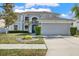 Two-story house with gray siding, dark green door, and a two-car garage at 11120 Kempton Vista Dr, Riverview, FL 33579