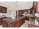 Spacious kitchen with dark wood cabinets and granite countertops at 11120 Kempton Vista Dr, Riverview, FL 33579