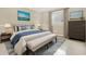 Main bedroom with a king-size bed and bench at the foot at 11120 Kempton Vista Dr, Riverview, FL 33579