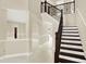 Elegant staircase with dark wood railings and white risers at 11120 Kempton Vista Dr, Riverview, FL 33579