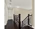 Upstairs hall with dark wood floors and ornate railing at 11120 Kempton Vista Dr, Riverview, FL 33579