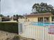 Community pool area with a fence and covered patio at 11122 Pembridge Ct # 2, Port Richey, FL 34668