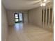 Spacious living room with tile floors and sliding glass doors at 11122 Pembridge Ct # 2, Port Richey, FL 34668