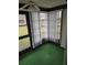 Sunroom featuring green carpet and vertical blinds at 11122 Pembridge Ct # 2, Port Richey, FL 34668