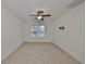 Spacious bedroom with large window and ceiling fan at 11520 Koti Creek Ln, Thonotosassa, FL 33592