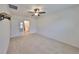 Bedroom with ceiling fan, carpeted floor, and access to bathroom at 11520 Koti Creek Ln, Thonotosassa, FL 33592