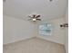 Bright bedroom with ceiling fan, large window and carpeted floors at 11520 Koti Creek Ln, Thonotosassa, FL 33592