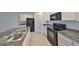 Modern kitchen featuring black appliances and granite countertops at 11520 Koti Creek Ln, Thonotosassa, FL 33592