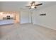 Bright and spacious living room with carpeted floors and ceiling fan at 11520 Koti Creek Ln, Thonotosassa, FL 33592