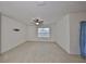 Spacious living room featuring carpeted floors and a ceiling fan at 11520 Koti Creek Ln, Thonotosassa, FL 33592