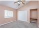 Bright bedroom with ceiling fan, window, and built-in shelving at 11938 Royce Waterford Cir, Tampa, FL 33626