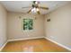 Well-lit bedroom with hardwood floors and ceiling fan at 11938 Royce Waterford Cir, Tampa, FL 33626