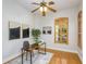 Home office with wood desk, and natural light from large windows at 11938 Royce Waterford Cir, Tampa, FL 33626