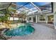 Resort-style pool and patio with covered lanai at 11938 Royce Waterford Cir, Tampa, FL 33626