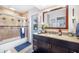 Elegant bathroom with dark vanity, tiled shower, and pool view at 1230 Nelson St, Dunedin, FL 34698