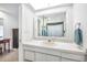 Bright bathroom with single sink vanity, shower, and mirrored medicine cabinet at 1230 Nelson St, Dunedin, FL 34698