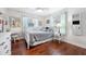 Charming bedroom with hardwood floors, a full-size bed, and a window seat at 1230 Nelson St, Dunedin, FL 34698