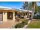 Front entrance with a welcoming porch and nicely landscaped yard at 1230 Nelson St, Dunedin, FL 34698