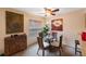 Bright dining area with glass table and four chairs, hardwood floors and wall art at 1290 83Rd N Ave # D, St Petersburg, FL 33702