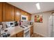 Kitchen features white appliances and oak wood cabinets at 1290 83Rd N Ave # D, St Petersburg, FL 33702