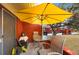 Private patio with table and chairs and yellow umbrella at 1290 83Rd N Ave # D, St Petersburg, FL 33702