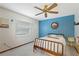 Bedroom with wood bed frame, blue walls, and window blinds at 13494 Tyringham St, Spring Hill, FL 34609